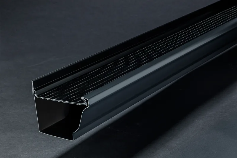 Installer positioning an Alu-Rex continuous hanger gutter guard